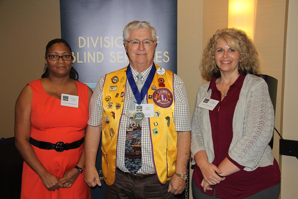 A representative from the Pensacola Lions Club standing with DBS staff members Allison Flannigan and Cynthia Lyons during the Successful 75 Award presentation. 